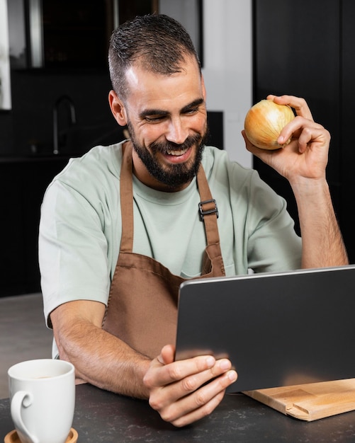 Medium shot man holding onion