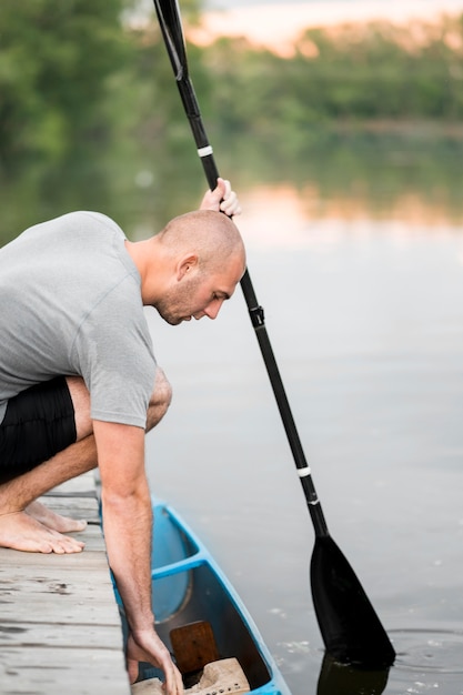 Medium shot man holding paddle