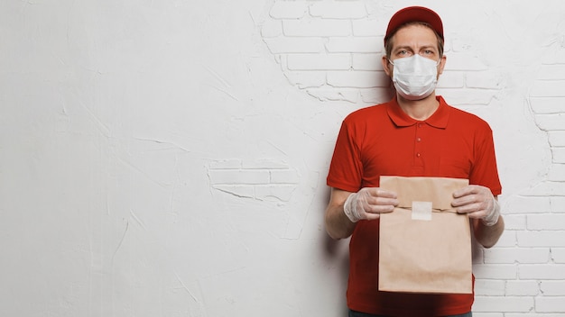 Medium shot man holding paper bag