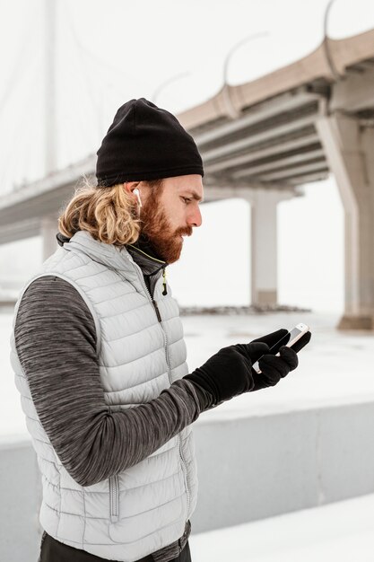 Medium shot man holding phone