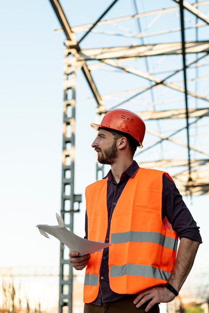 Medium shot of man holding plan