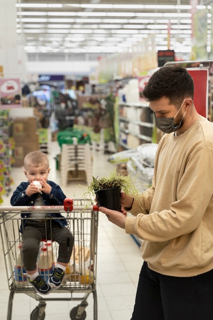 Medium shot man holding potted plant