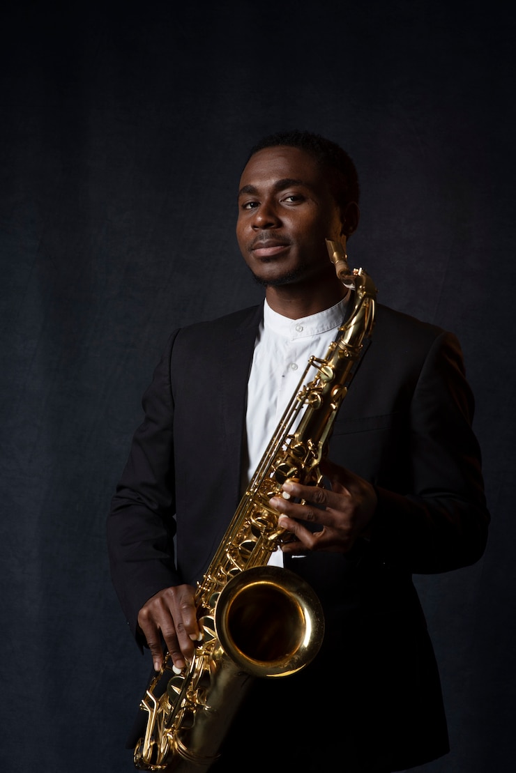 Free Photo medium shot man holding saxophone