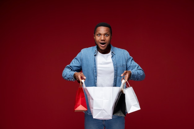 Free photo medium shot man holding shopping bags