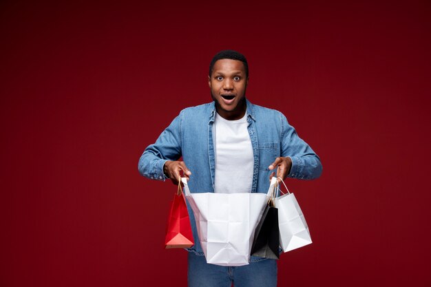 Medium shot man holding shopping bags