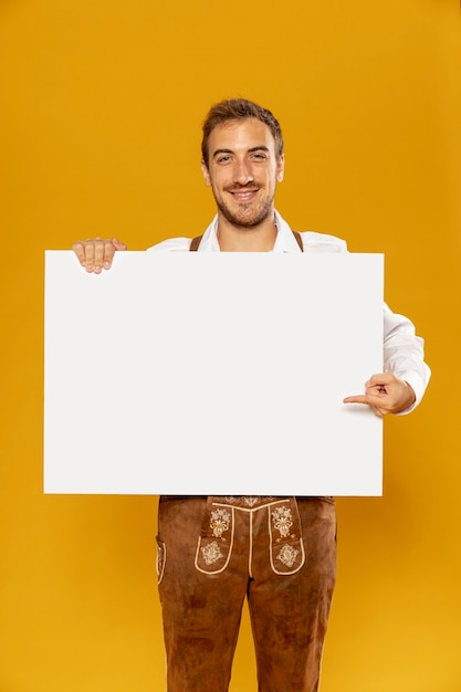 Medium shot of man holding sign mock-up