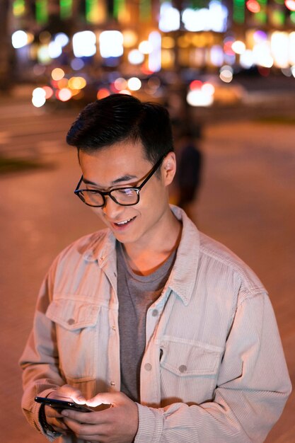 Medium shot man holding smartphone