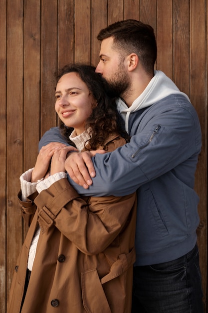 Medium shot man holding smiley woman