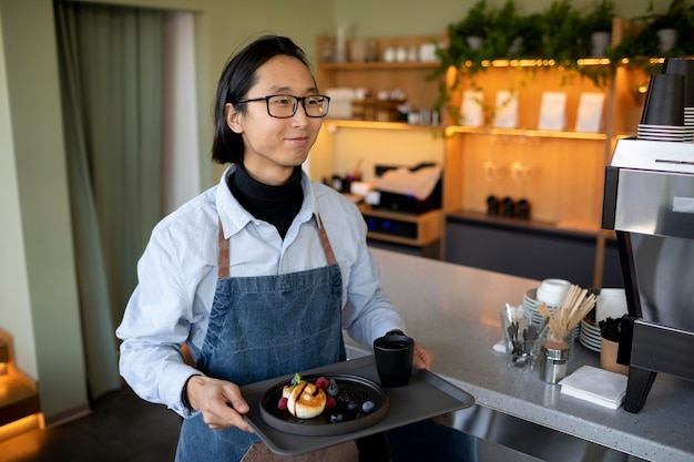 Medium shot man holding tray