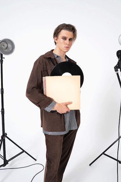 Medium shot man holding vinyl record