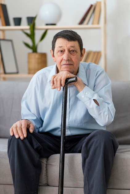 Medium shot man holding walking stick