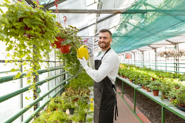 Free photo medium shot man holding watering can