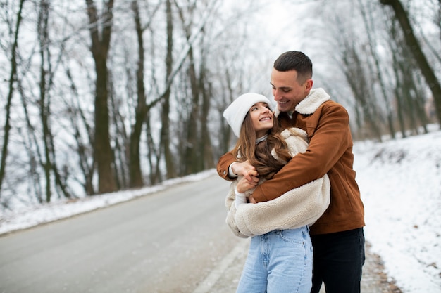 Medium shot man hugging woman