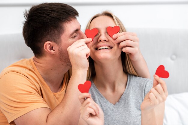 Medium shot man kissing woman on the cheek