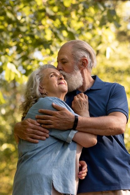 Medium shot man kissing woman on cheek