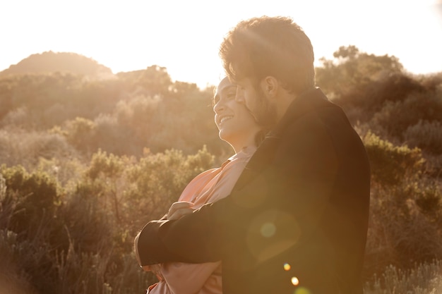 Medium shot man kissing woman on cheek