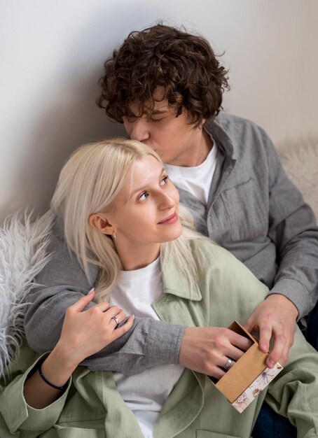 Medium shot man kissing woman on head