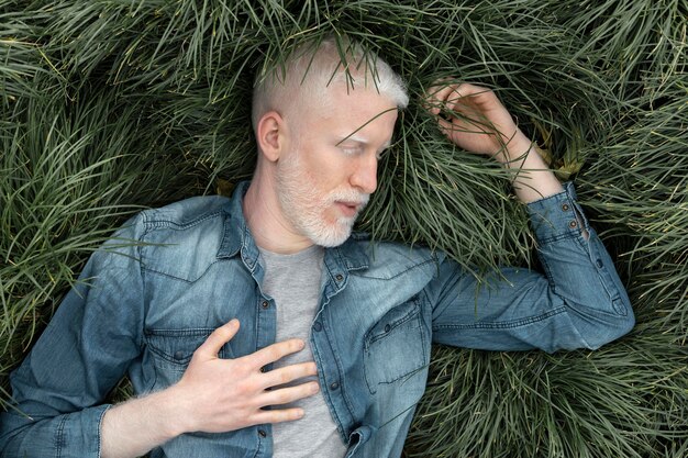 Medium shot man laying on grass