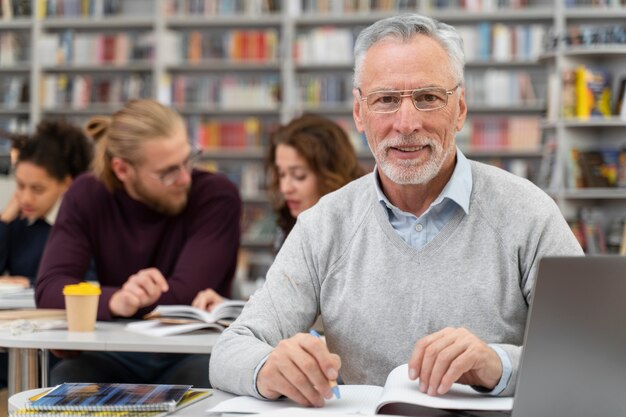 Medium shot man learning with laptop