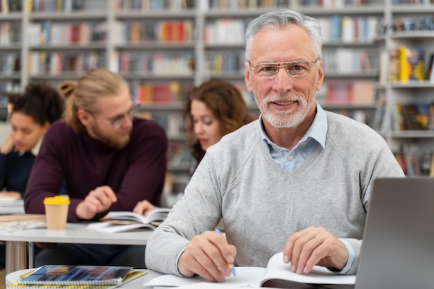 Medium shot man learning with laptop