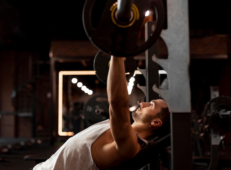 Free Photo medium shot man lifting bar side view