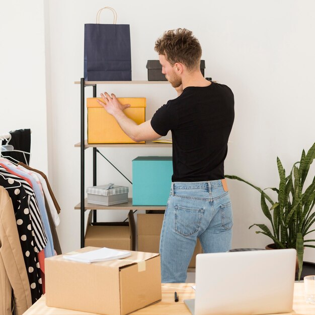 Medium shot man looking at box