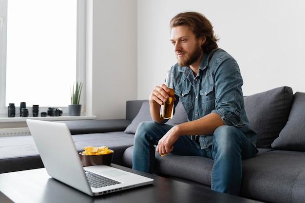 Free photo medium shot man looking at laptop