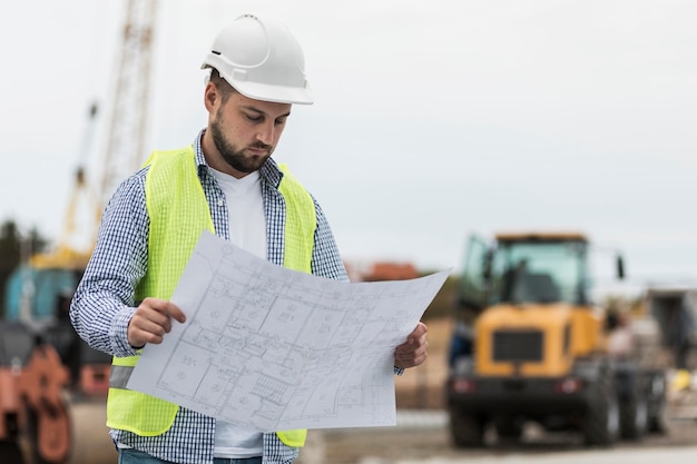 Free photo medium shot man looking at project