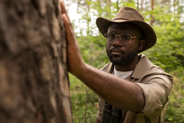 Medium shot man looking at tree