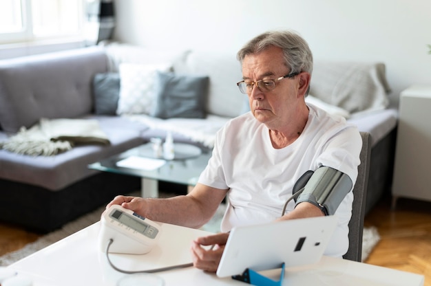 Medium shot man monitoring hid blood pressure