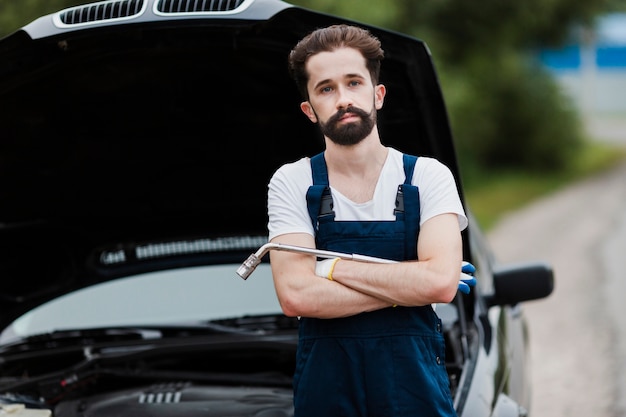 Free photo medium shot of man in overalls with wrench