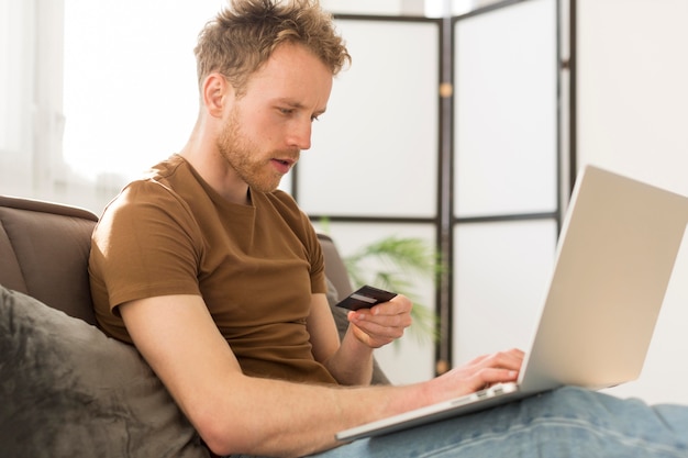 medium shot man paying with card