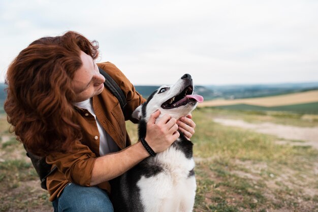 Medium shot man petting dog