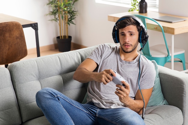 Medium shot man playing on couch