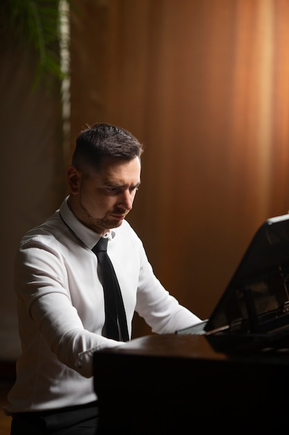 Medium shot man playing piano