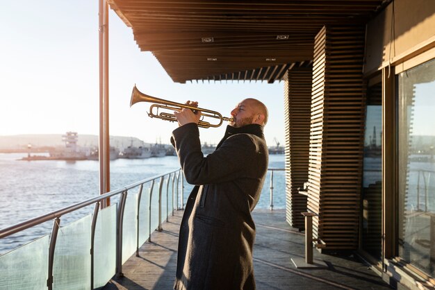 Medium shot man playing trumpet