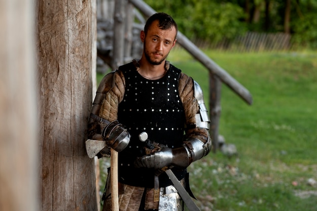 Free photo medium shot man posing as a medieval soldier