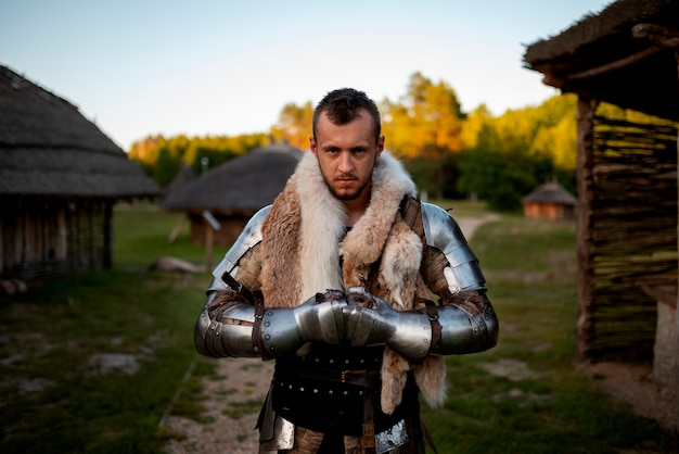 Free photo medium shot man posing as a medieval soldier