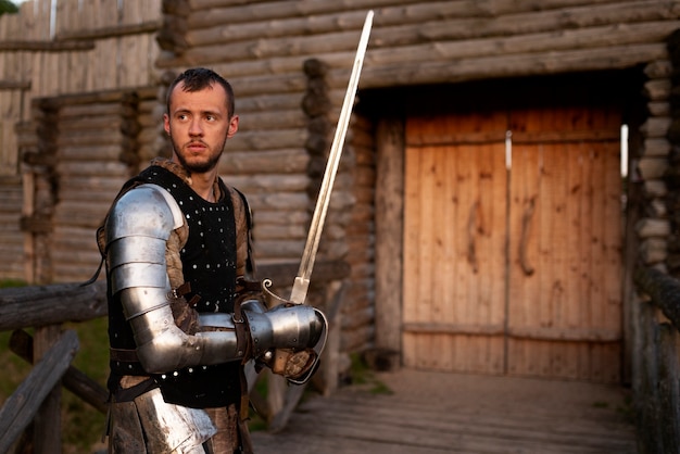 Free photo medium shot man posing as a medieval soldier