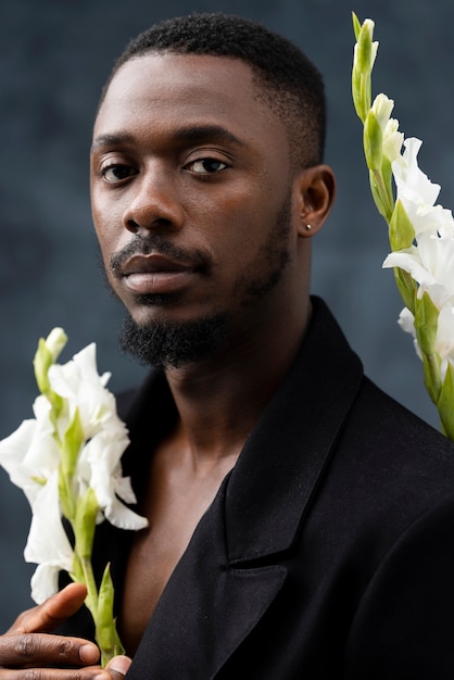 Medium shot man posing with flowers