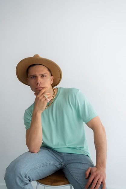 Medium shot man posing with hat