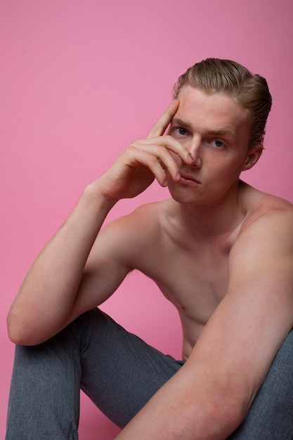 Medium shot man posing with pink background