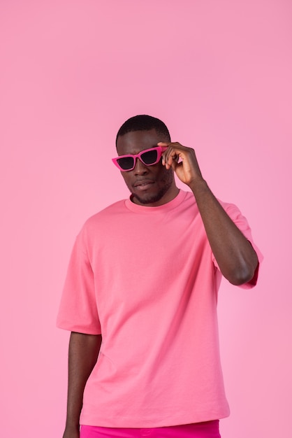 Medium shot man posing with pink outfit