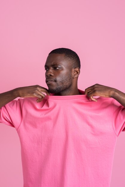 Medium shot man posing with pink outfit