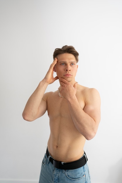 Medium shot man posing without shirt