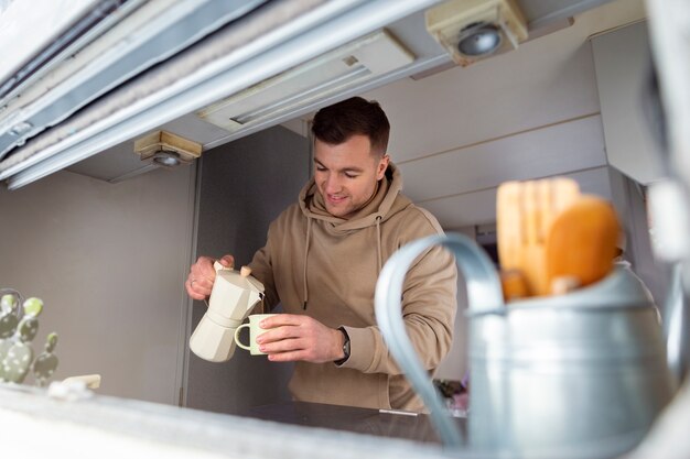 Medium shot man pouring coffee