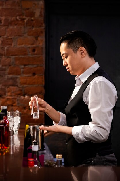 Medium shot man preparing drink