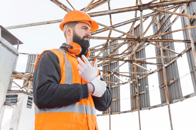 Medium shot man putting on gloves for work