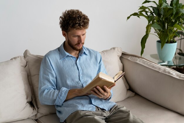 Medium shot man reading at home