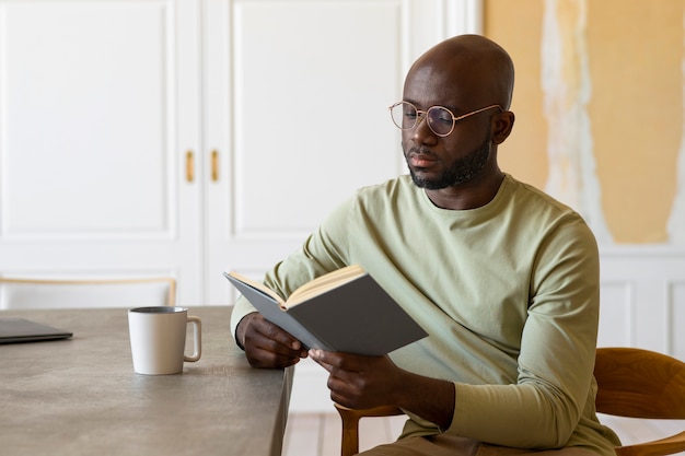 Medium shot man reading indoors